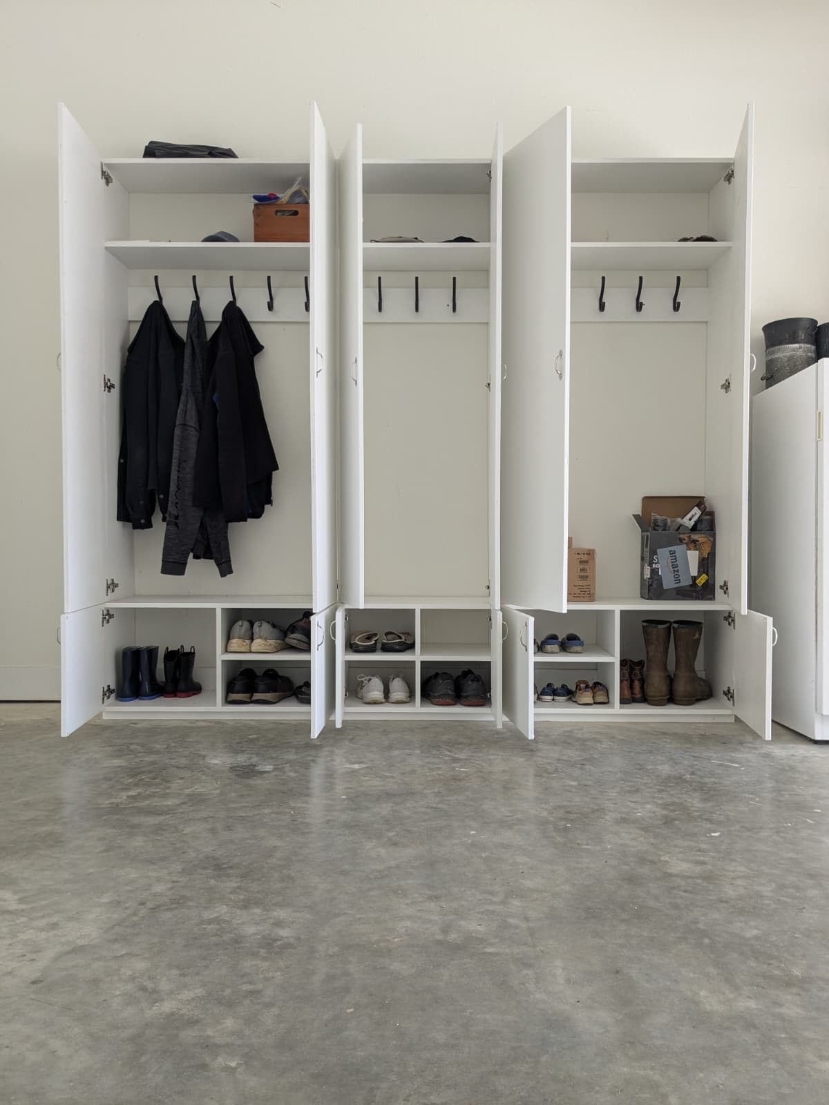 Custom built-in mudroom lockers with coat hooks and shoe storage