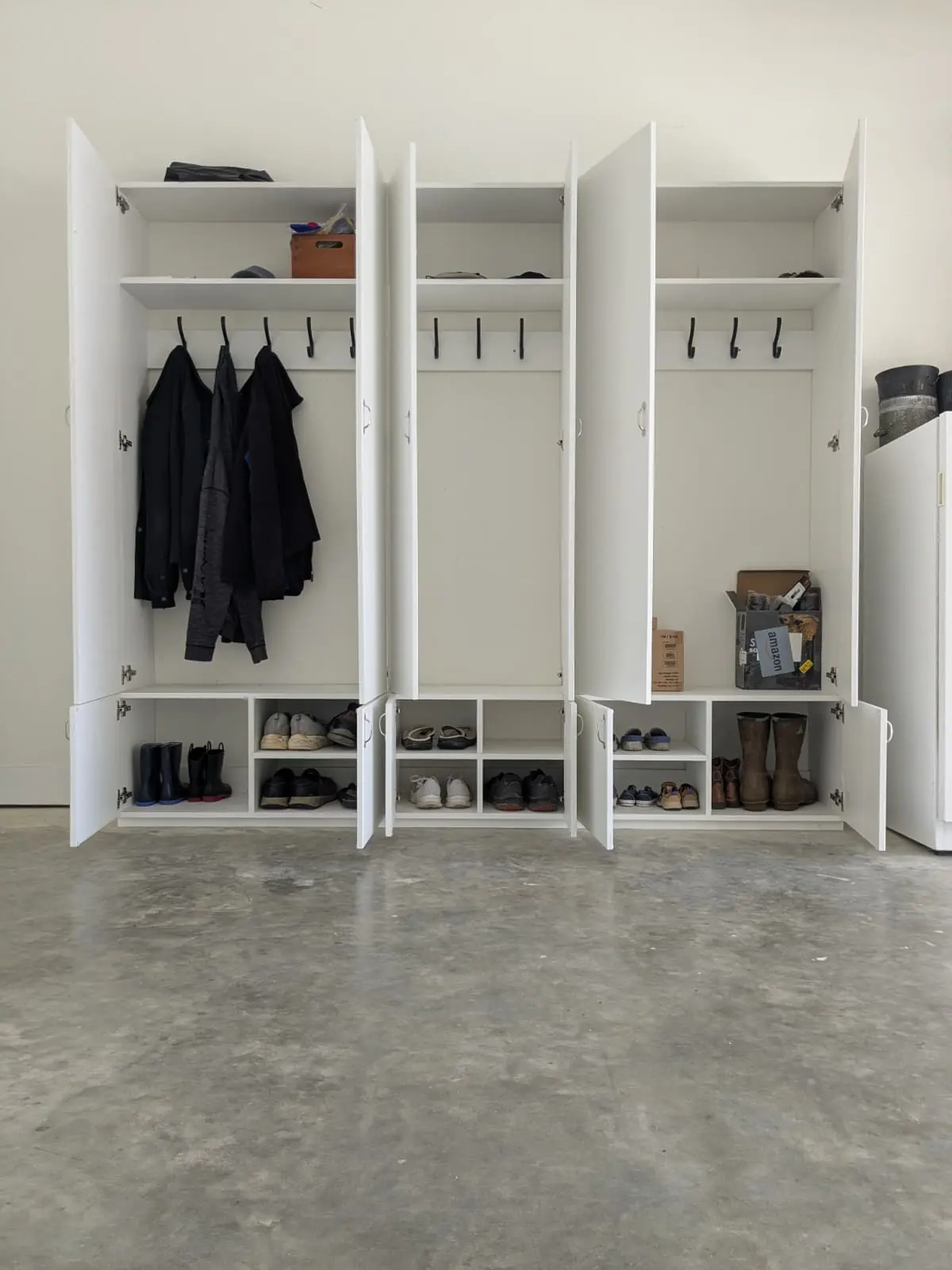 Custom built-in mudroom lockers with coat hooks and shoe storage