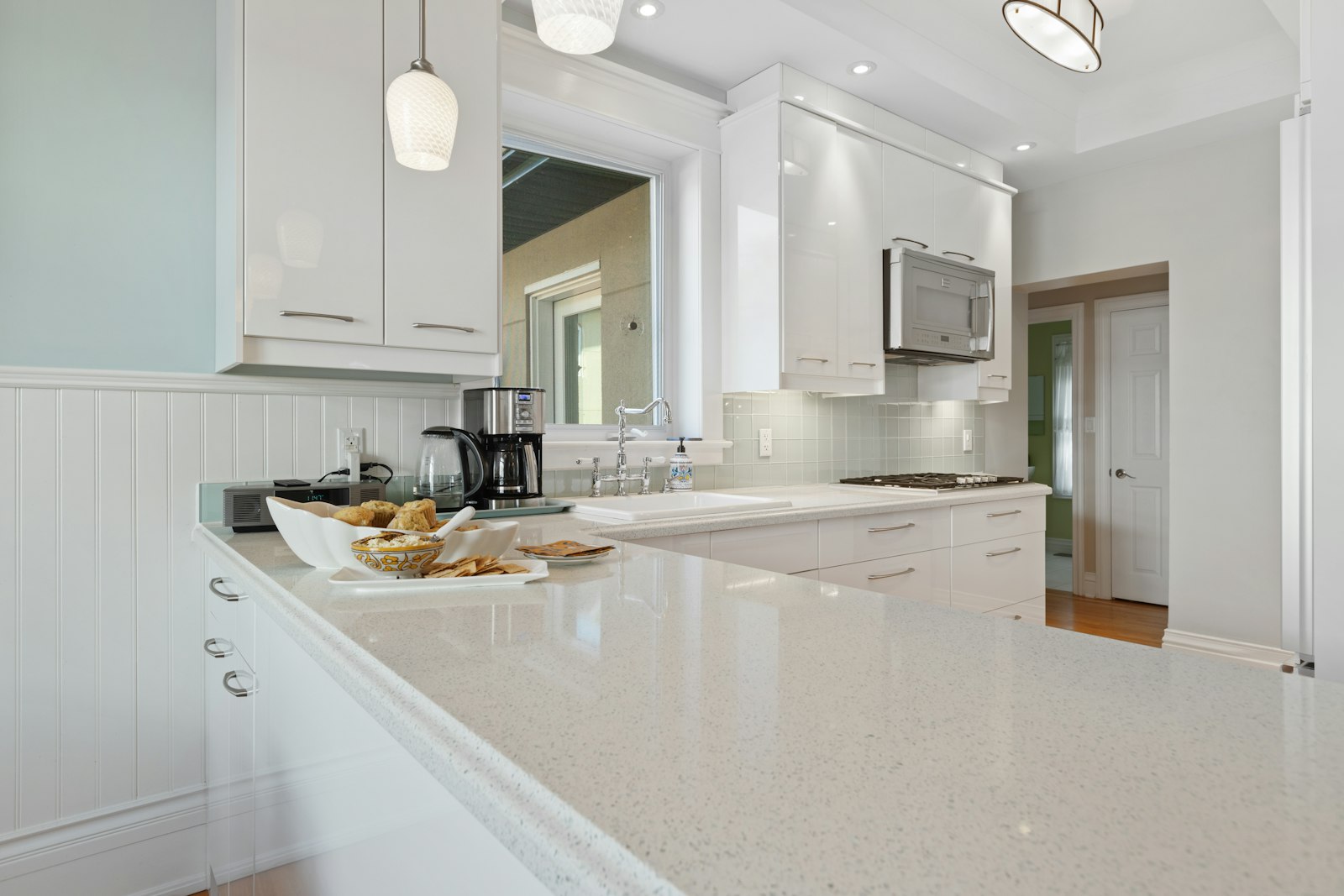 Kitchen with white cabinetry and countertops