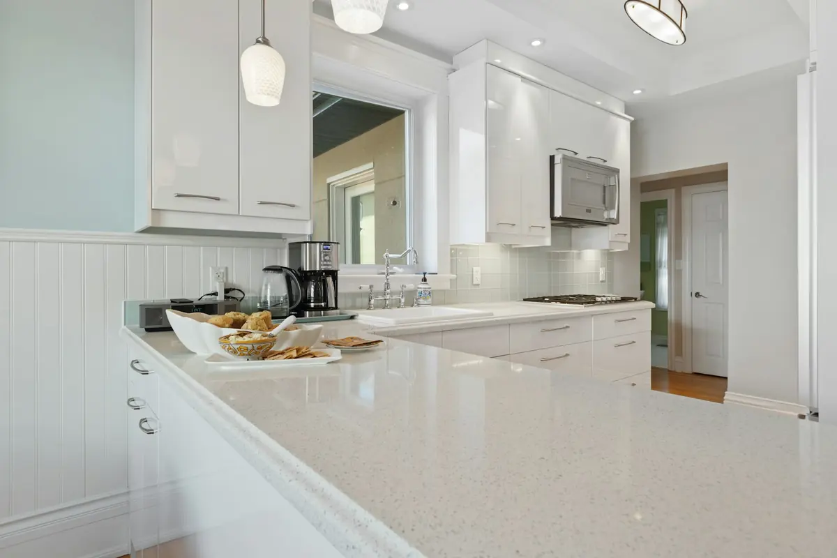 Kitchen with white cabinetry and countertops