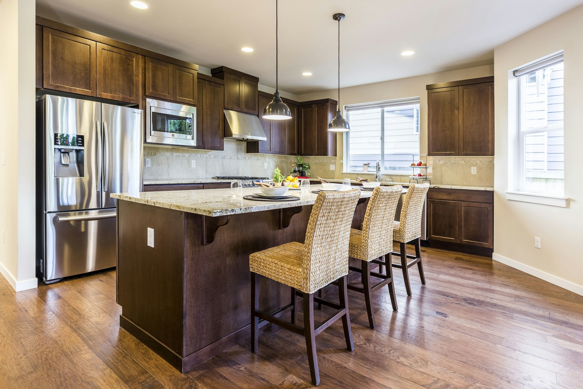 Kitchen with wood cabinetry, granite island, and stainless appliances