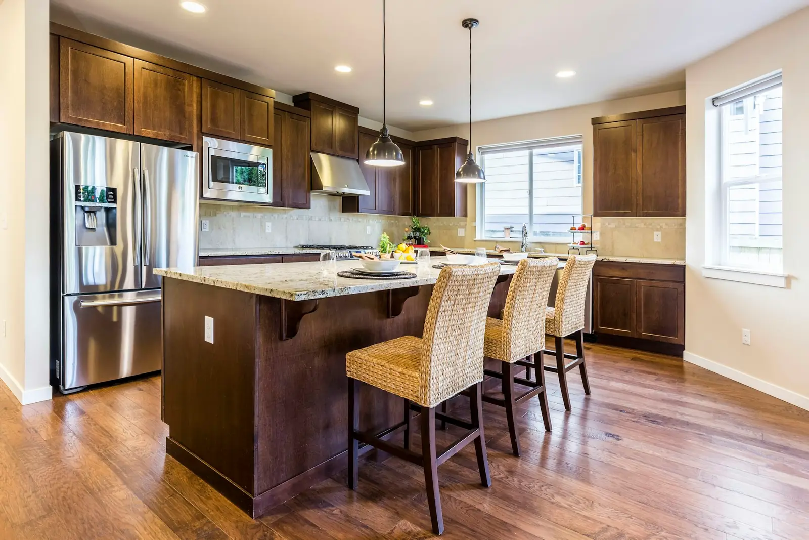 Kitchen with wood cabinetry, granite island, and stainless appliances